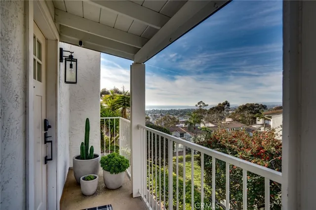 a view of a balcony with chair potted plant