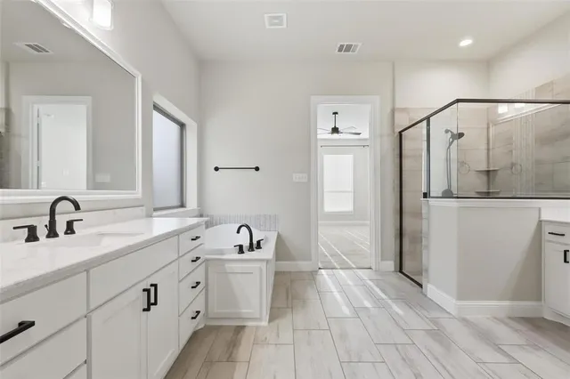 a bathroom with a granite countertop sink mirror and vanity