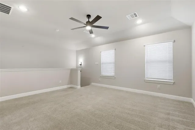 wooden floor in an empty room and a ceiling fan
