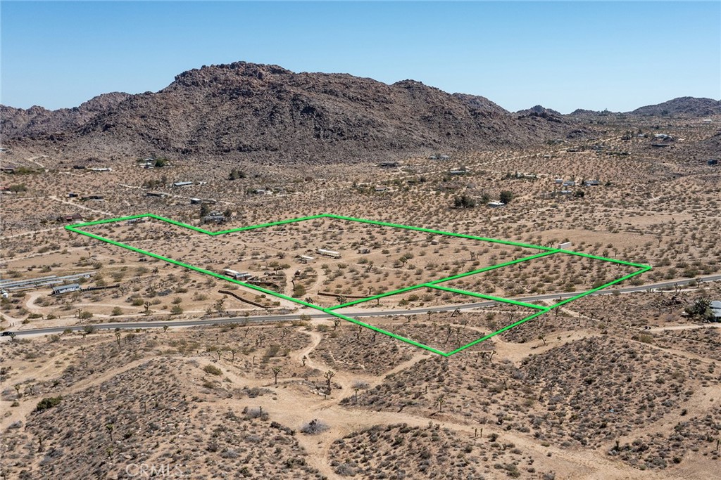 62600 Quail Springs Road Joshua Tree, CA 92252 - Photo 1 of 1 a view of a dry field with mountains in the background