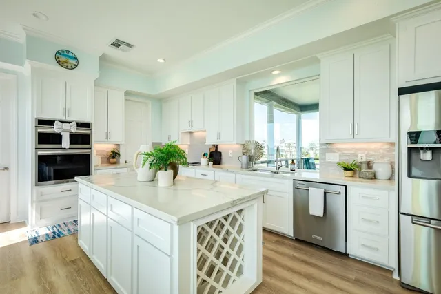 a kitchen with stainless steel appliances kitchen island granite countertop a sink and cabinets