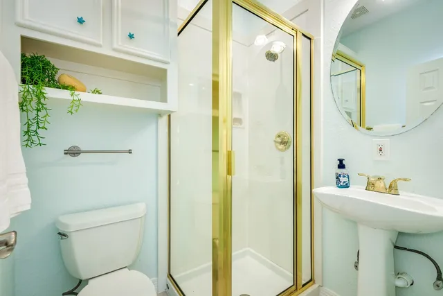 a bathroom with a sink toilet and shower