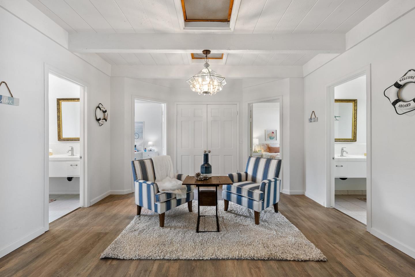 1272 Castro Road Monterey, CA 93940 - Photo 32 of 54 a dining room with furniture a chandelier and wooden floor