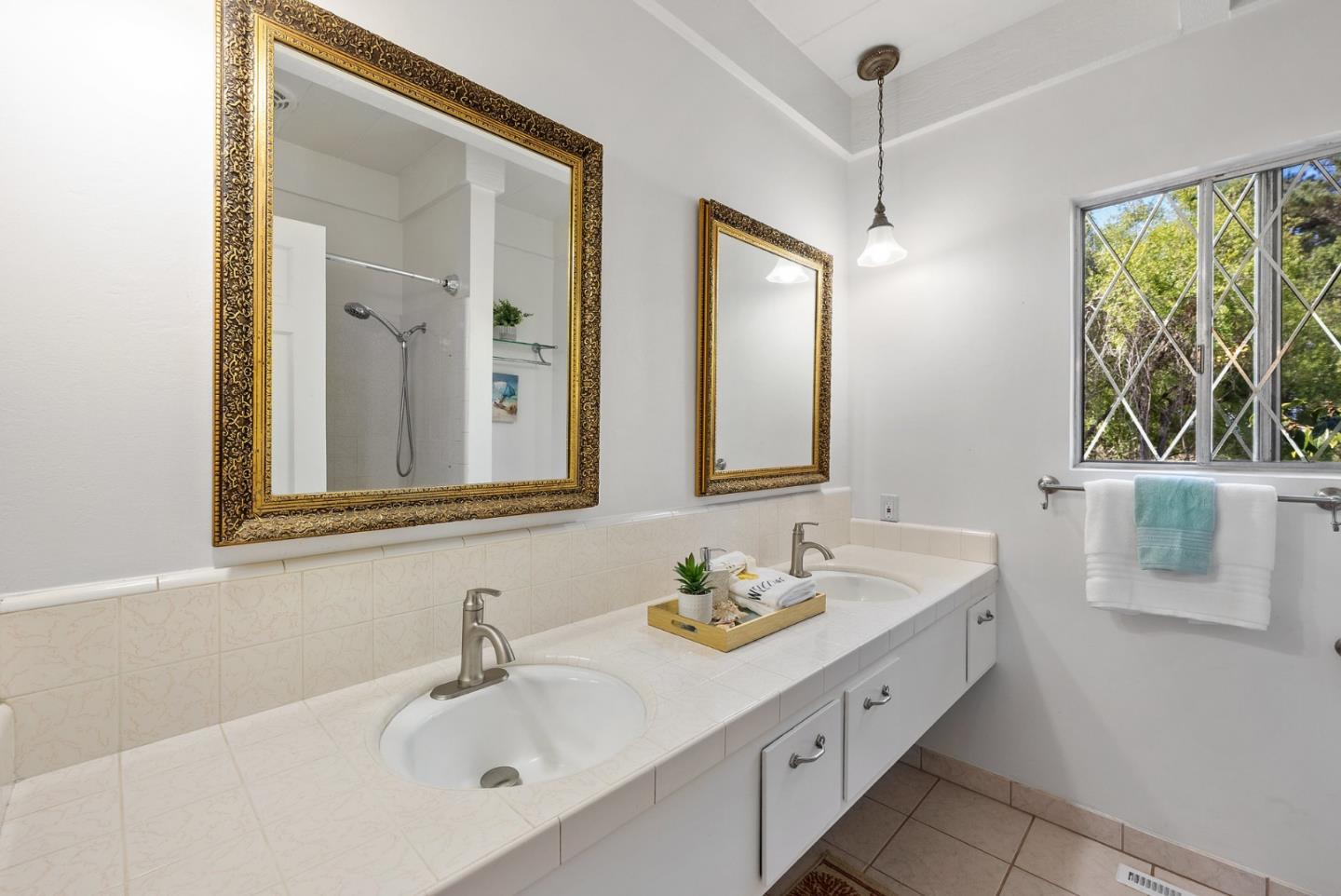 1272 Castro Road Monterey, CA 93940 - Photo 41 of 54 a bathroom with a double vanity sink window and a mirror