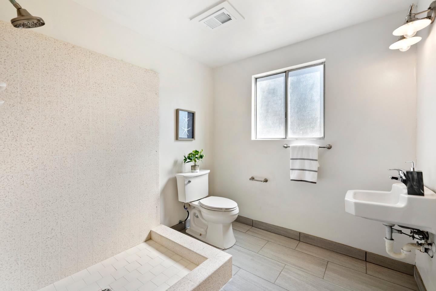 1272 Castro Road Monterey, CA 93940 - Photo 52 of 54 a white toilet sitting next to a bathroom sink