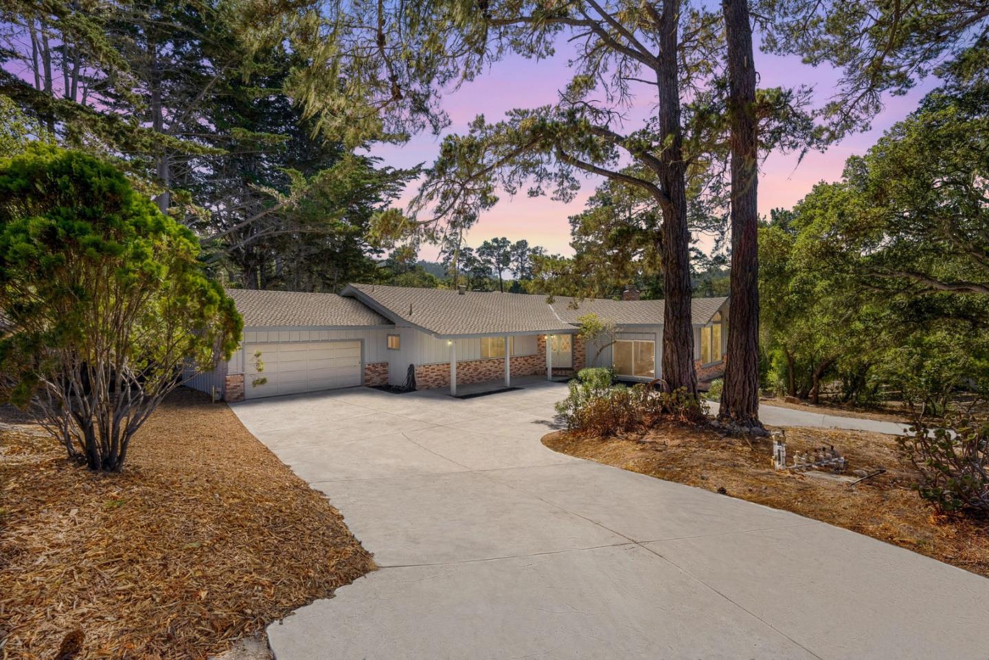 1272 Castro Road Monterey, CA 93940 - Photo 9 of 54 a backyard of a house with table and chairs and a large tree