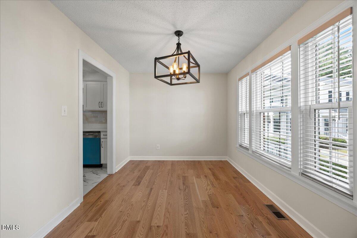 1932 Stroll Circle Fuquay-Varina, NC 27526 - Photo 2 of 24 a view of empty room with wooden floor and fan