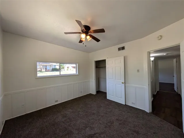 a view of empty room with ceiling fan