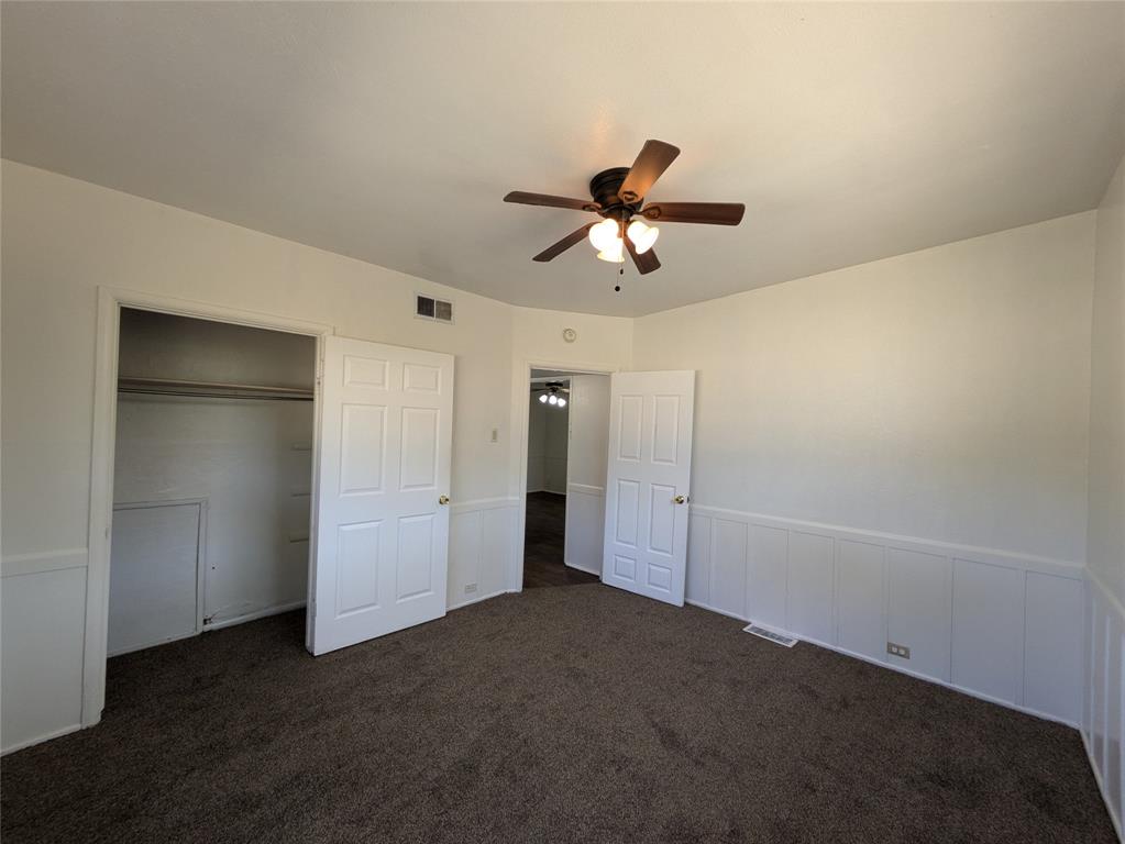 710 Boulevard Boulevard North Dallas, TX 75211 - Photo 15 of 21 a view of empty room with wooden floor and ceiling fan