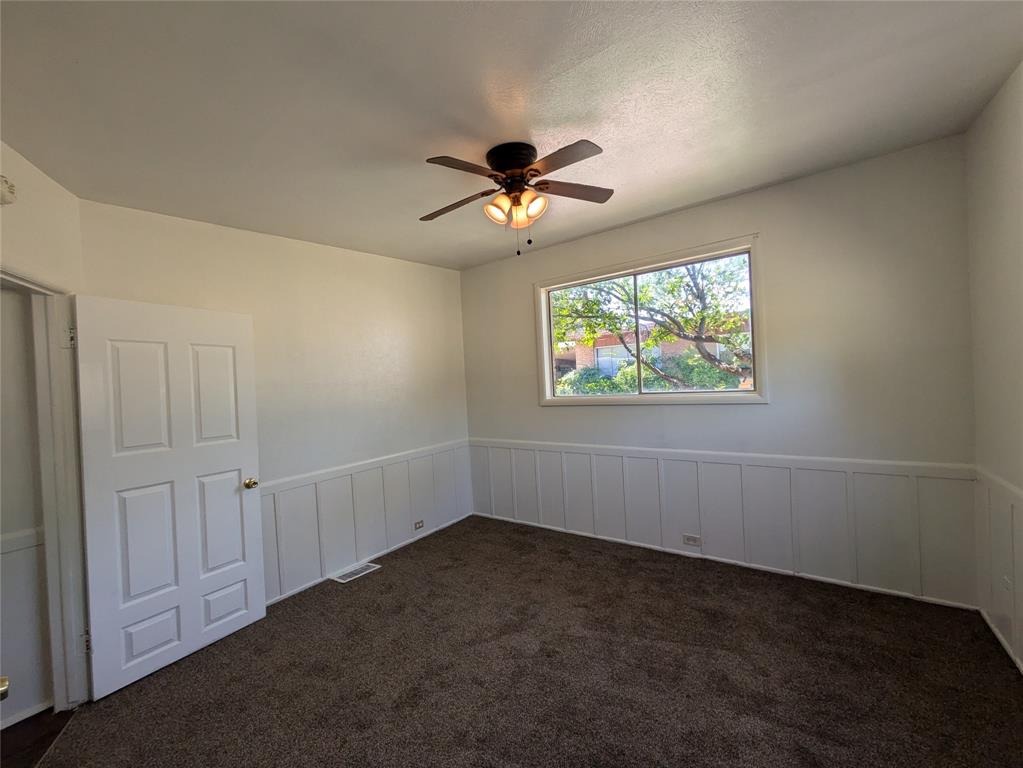710 Boulevard Boulevard North Dallas, TX 75211 - Photo 16 of 21 an empty room with windows and fan