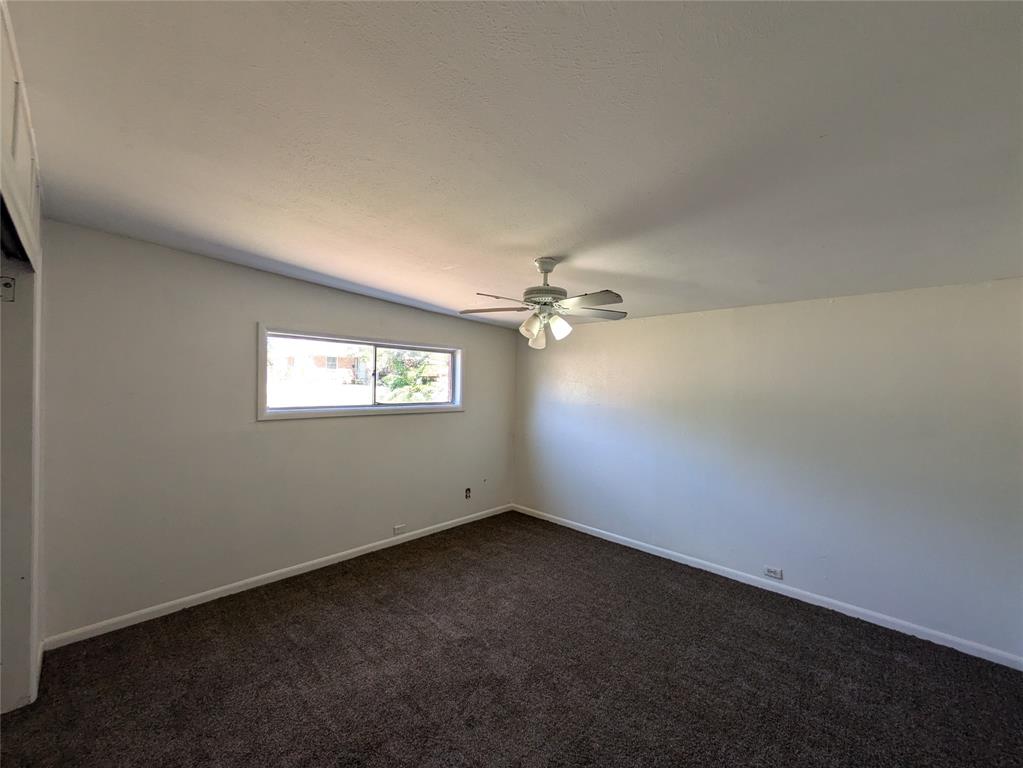 710 Boulevard Boulevard North Dallas, TX 75211 - Photo 17 of 21 an empty room with a window and a ceiling fan