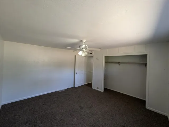 an empty room with a empty space and a ceiling fan