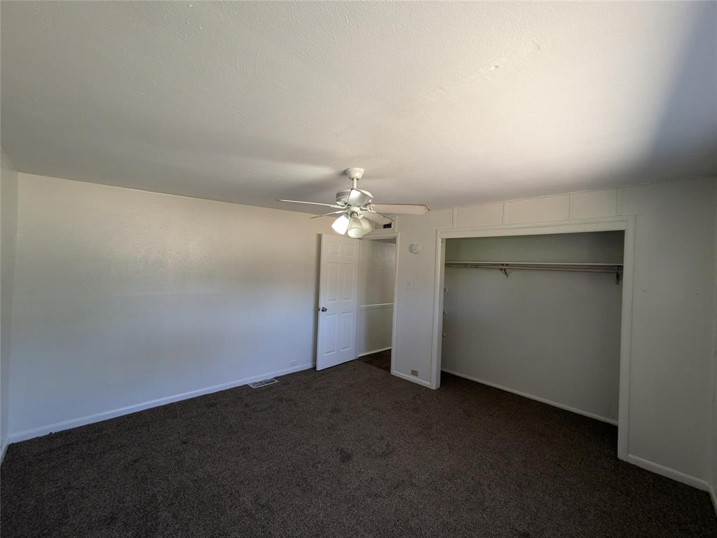 710 Boulevard Boulevard North Dallas, TX 75211 - Photo 19 of 21 an empty room with a empty space and a ceiling fan