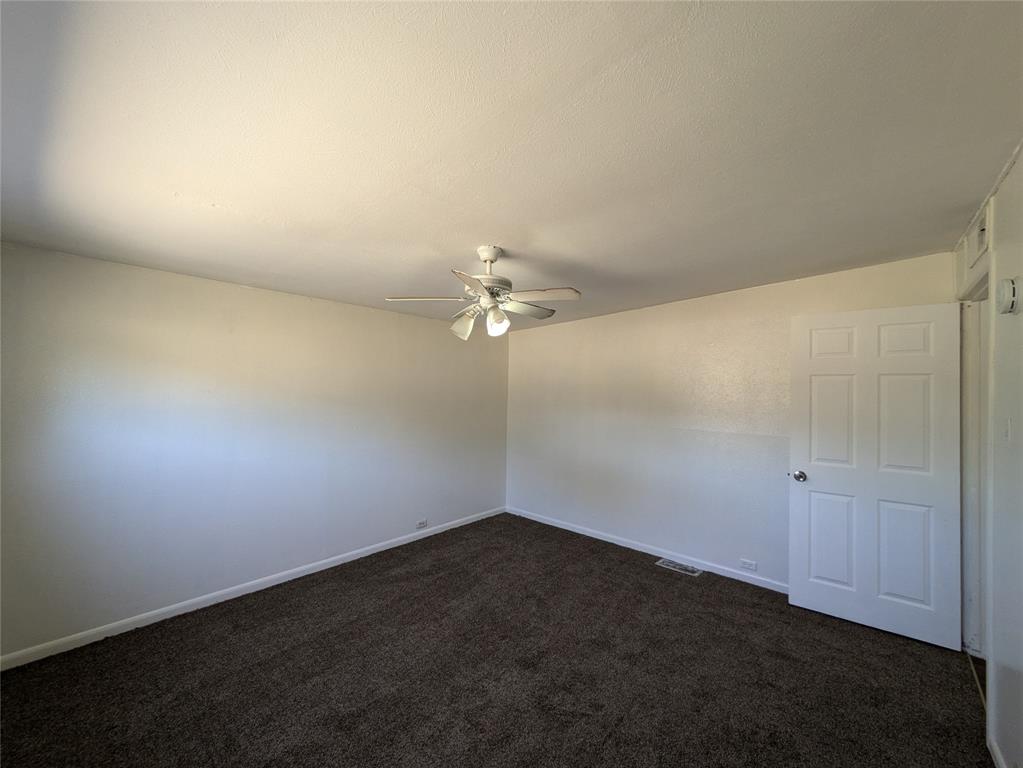 710 Boulevard Boulevard North Dallas, TX 75211 - Photo 20 of 21 an empty room with a fan & a ceiling fan
