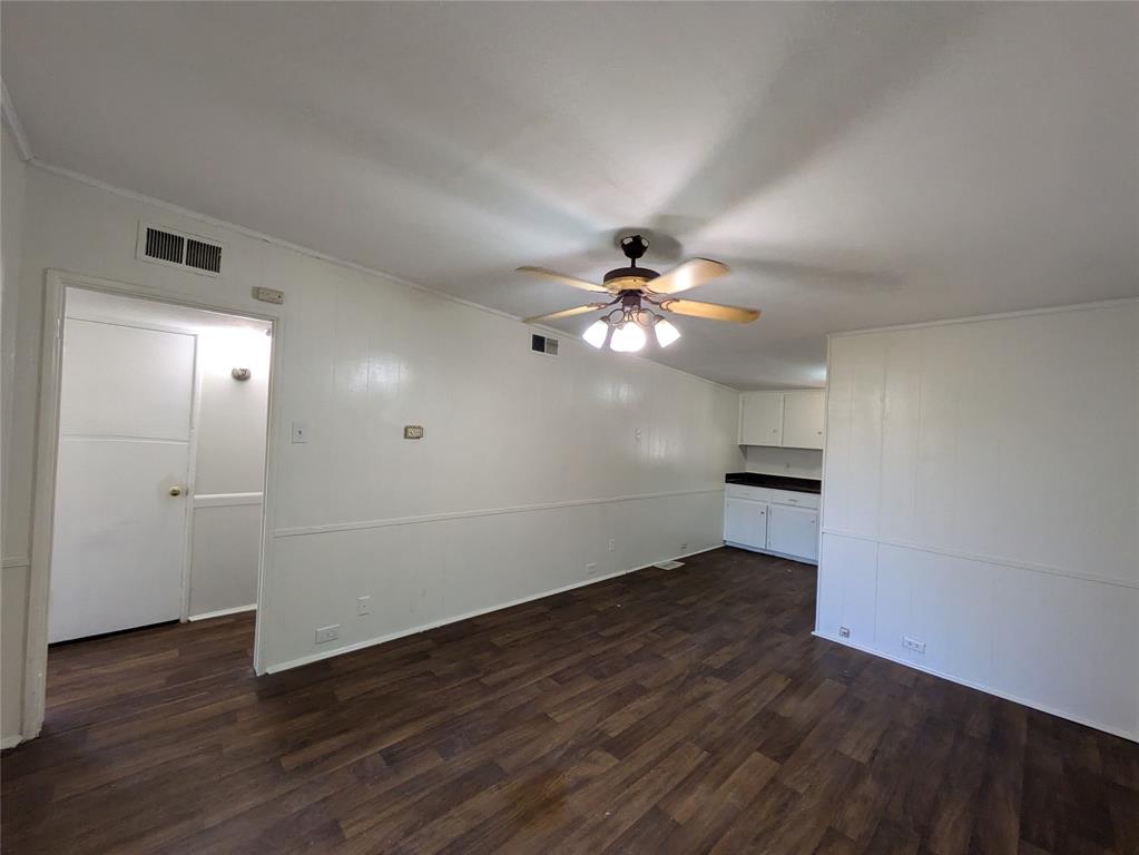 710 Boulevard Boulevard North Dallas, TX 75211 - Photo 3 of 21 an empty room with wooden floor fan and windows