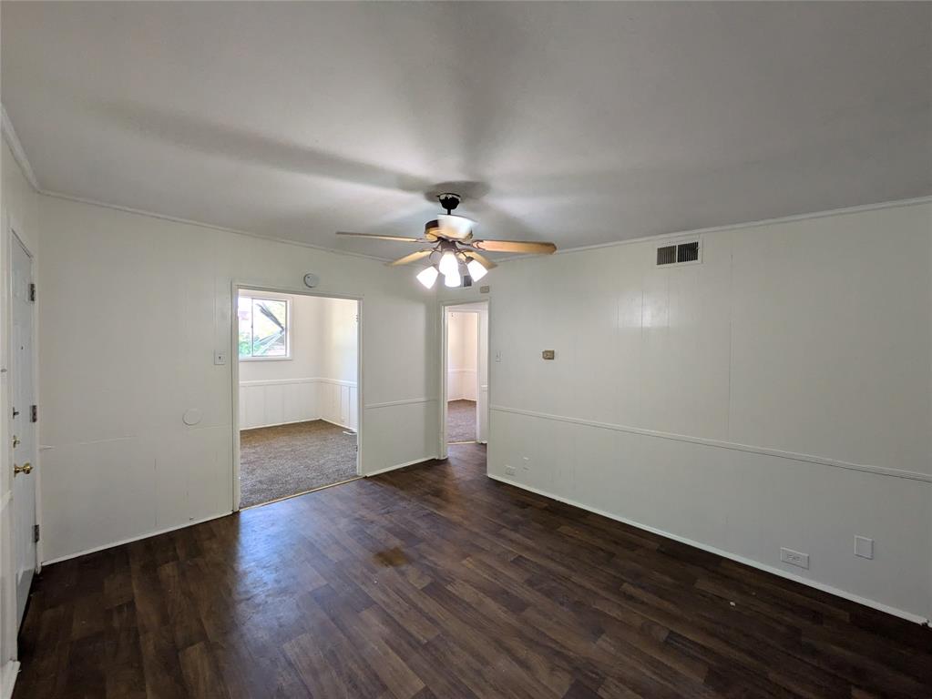 710 Boulevard Boulevard North Dallas, TX 75211 - Photo 4 of 21 wooden floor in an empty room with a window