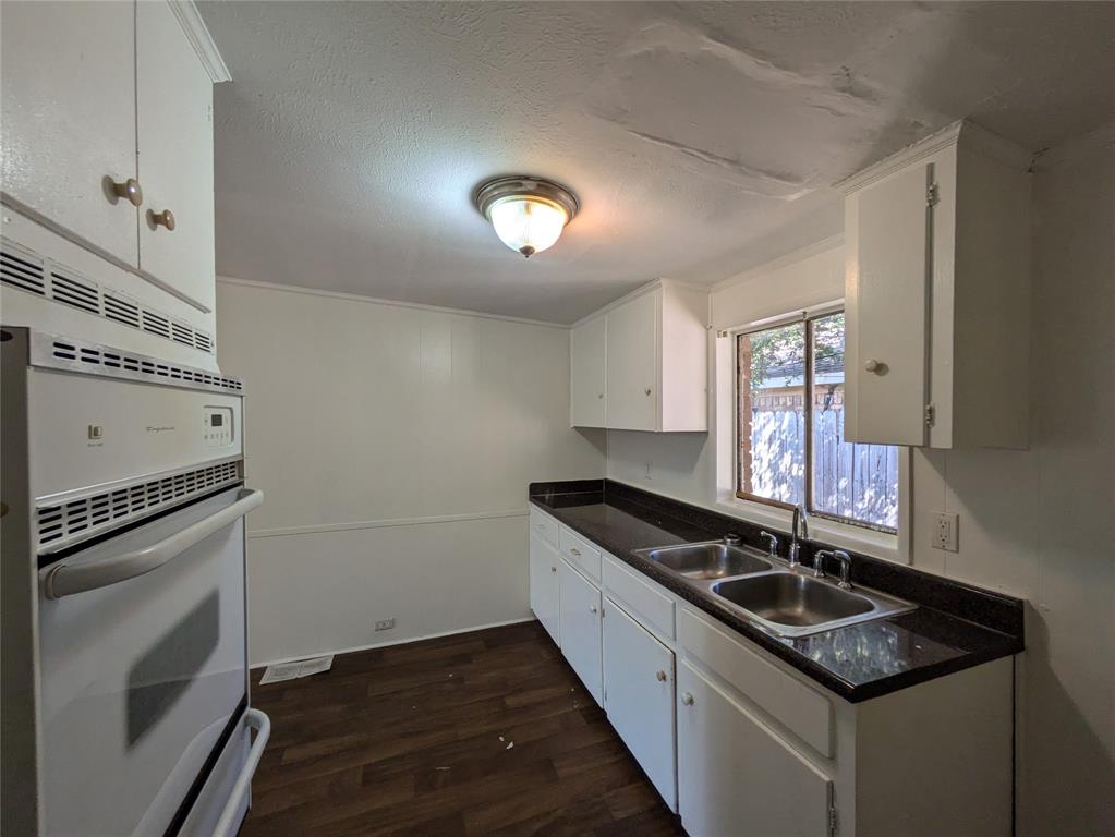 710 Boulevard Boulevard North Dallas, TX 75211 - Photo 9 of 21 a kitchen with granite countertop stainless steel appliances a stove sink and microwave