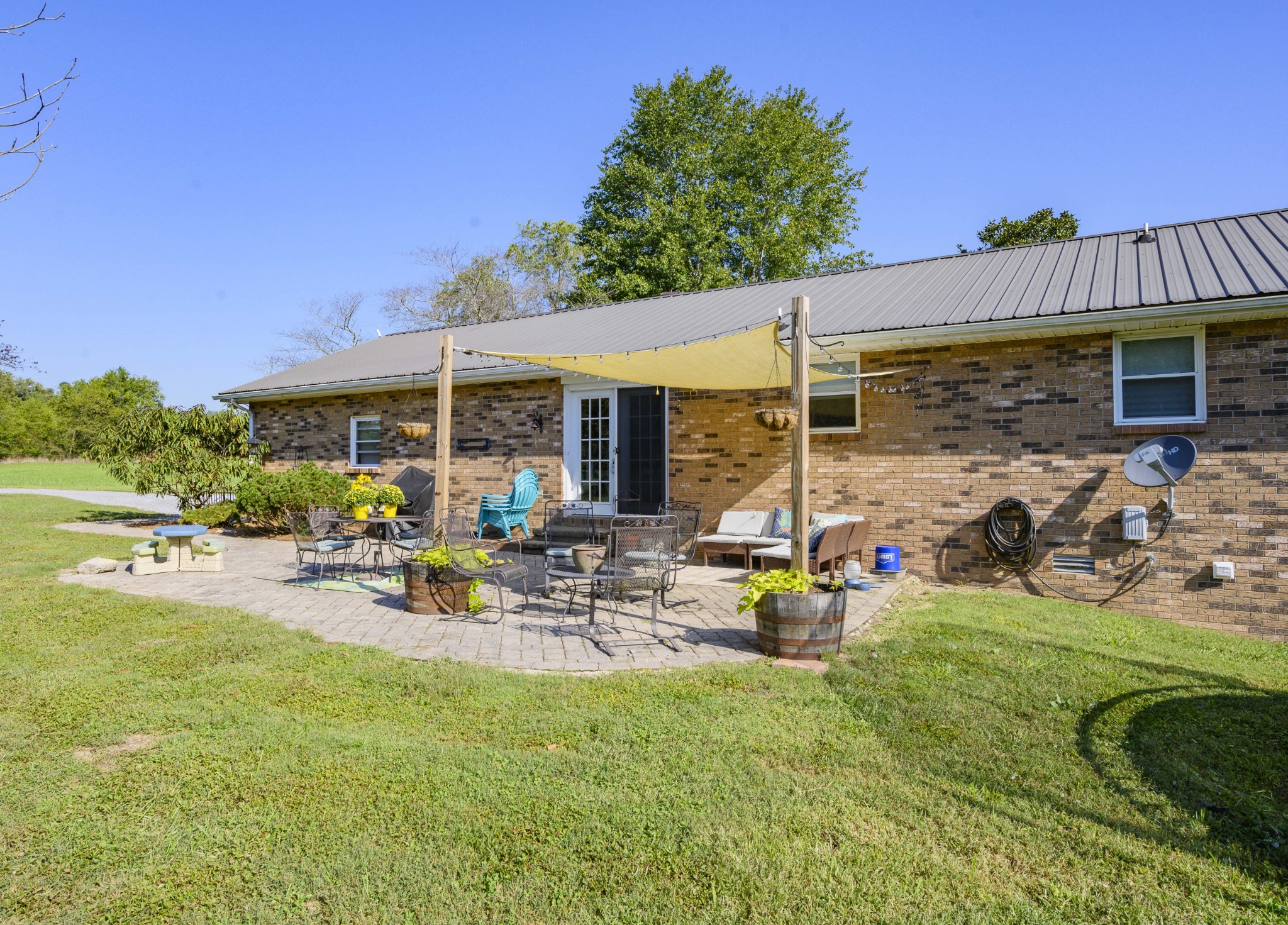 1430 Cedar Bluff Road Lebanon, TN 37087 - Photo 9 of 27 a view of a patio with table and chairs under an umbrella