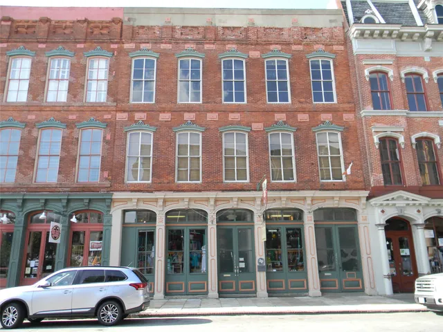 a front view of a building with parking space