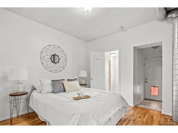 a bedroom with a bed and painting on the wall