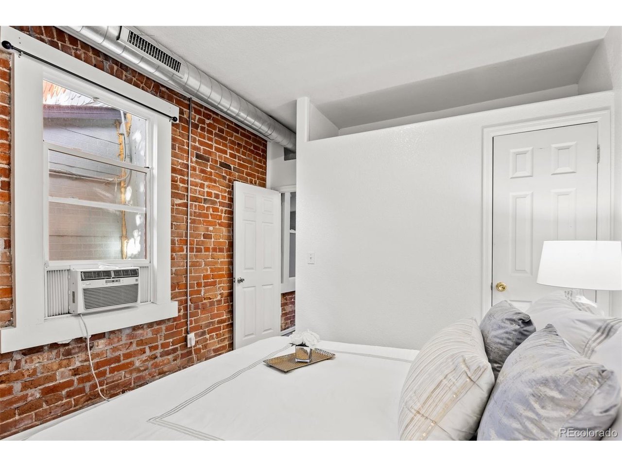 321 Inca Street Denver, CO 80223 - Photo 14 of 27 a bedroom with a bed and a window