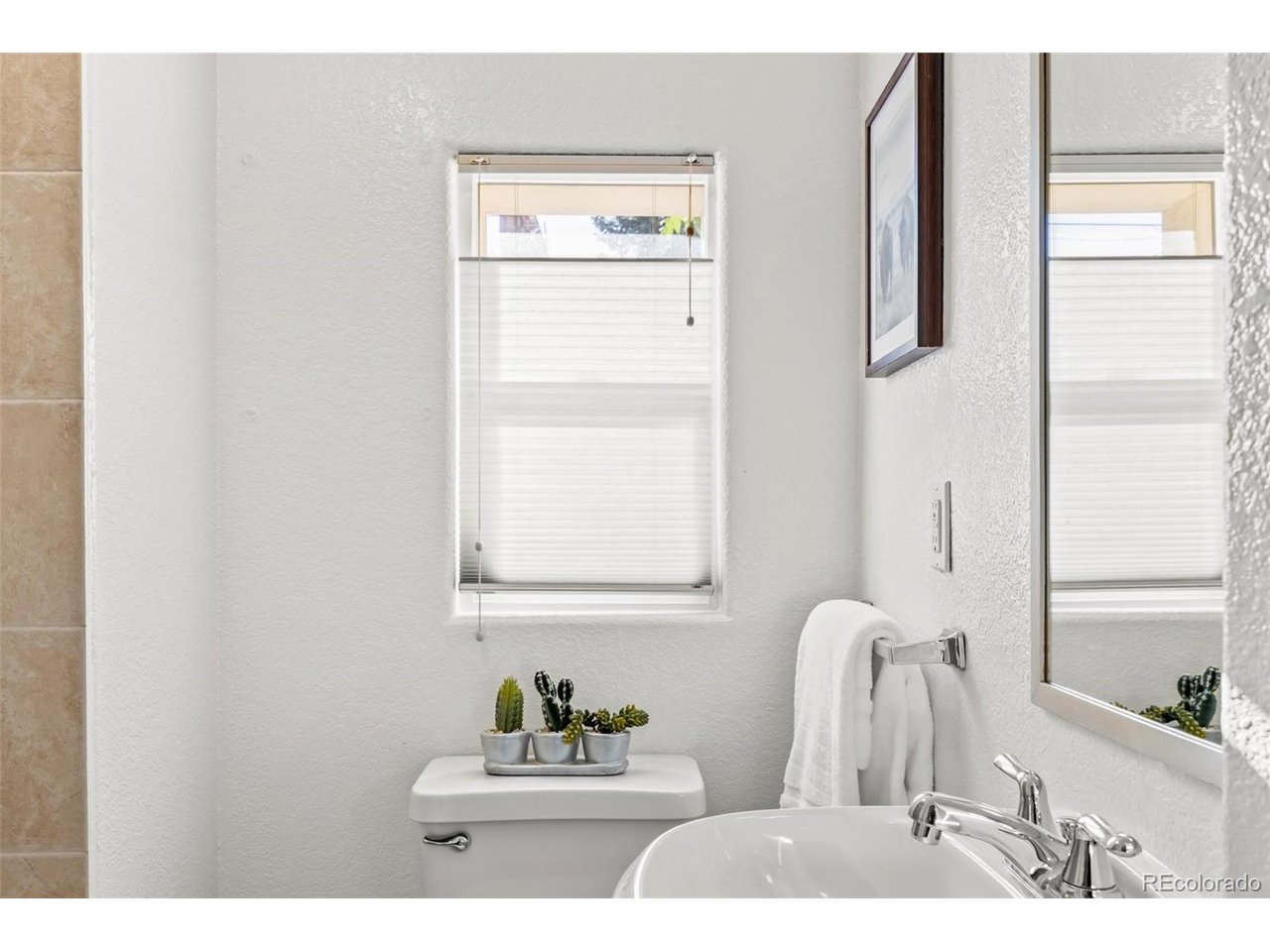 321 Inca Street Denver, CO 80223 - Photo 15 of 27 a bathroom with a sink vanity and a mirror
