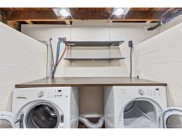a view of washer and dryer with kitchen in the background