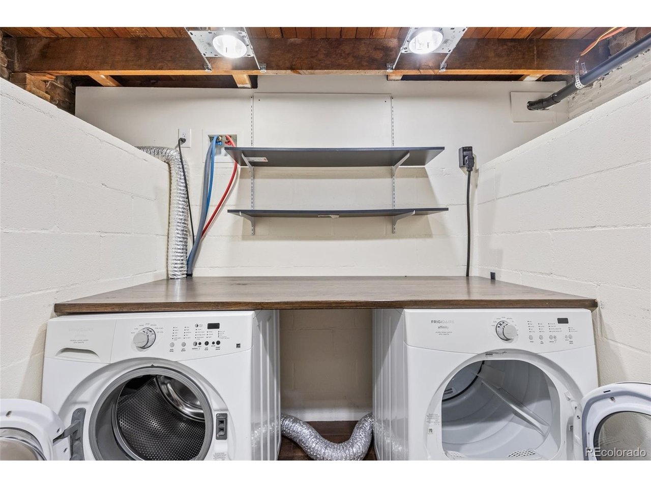 321 Inca Street Denver, CO 80223 - Photo 16 of 27 a view of washer and dryer with kitchen in the background