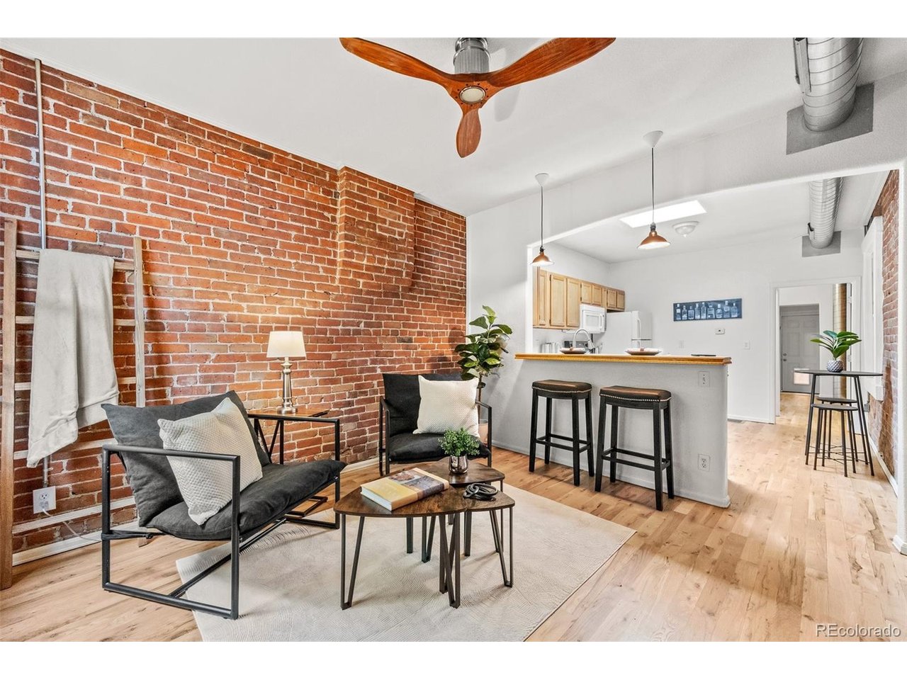 321 Inca Street Denver, CO 80223 - Photo 2 of 27 a dining room with furniture and wooden floor