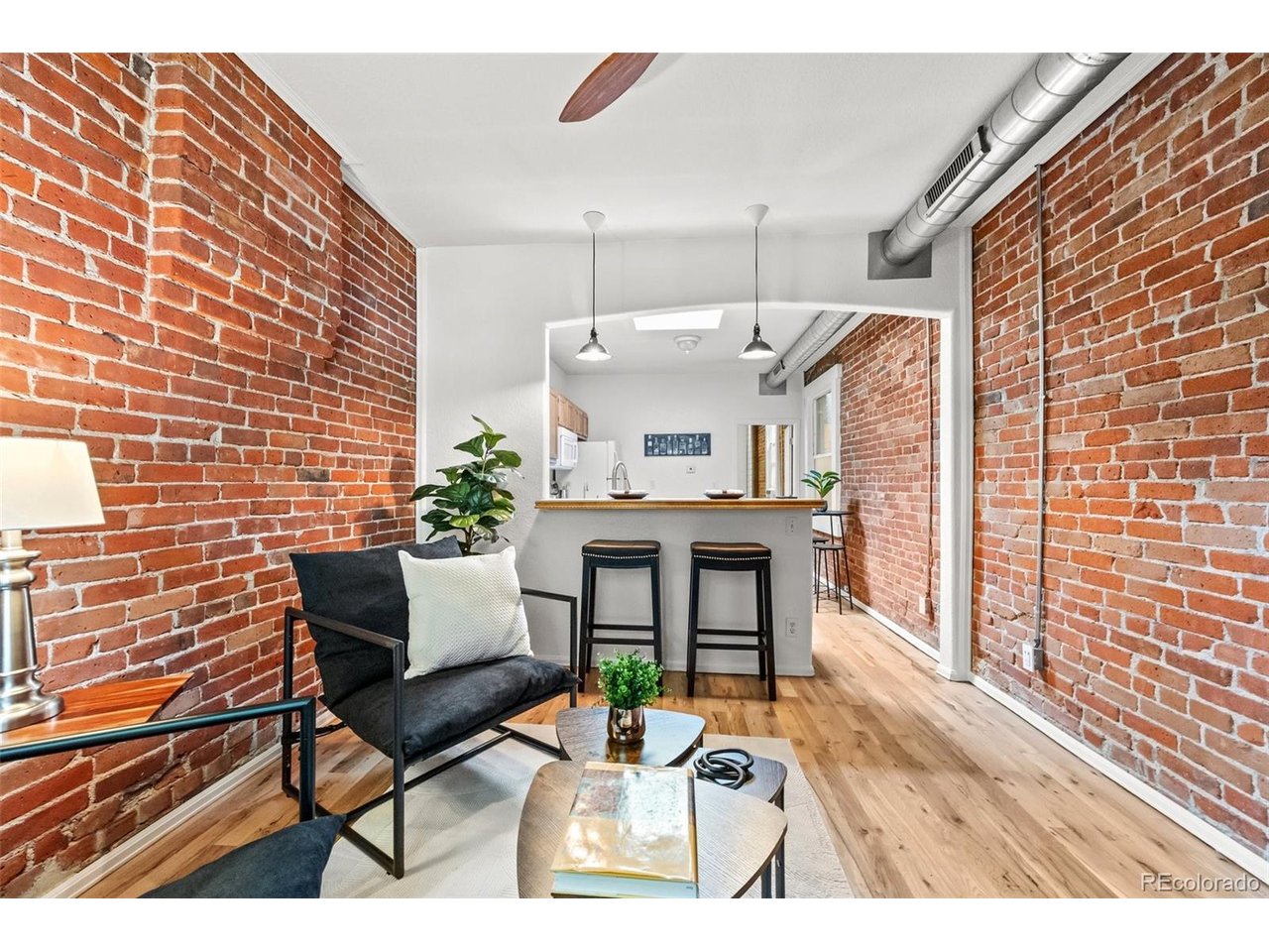 321 Inca Street Denver, CO 80223 - Photo 4 of 27 a view of a patio with table and chairs with wooden floor