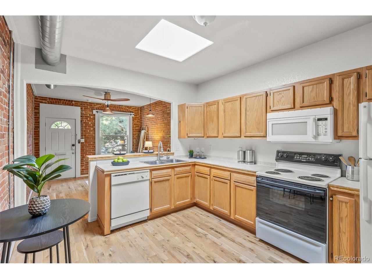 321 Inca Street Denver, CO 80223 - Photo 7 of 27 a kitchen with a stove a sink and cabinets