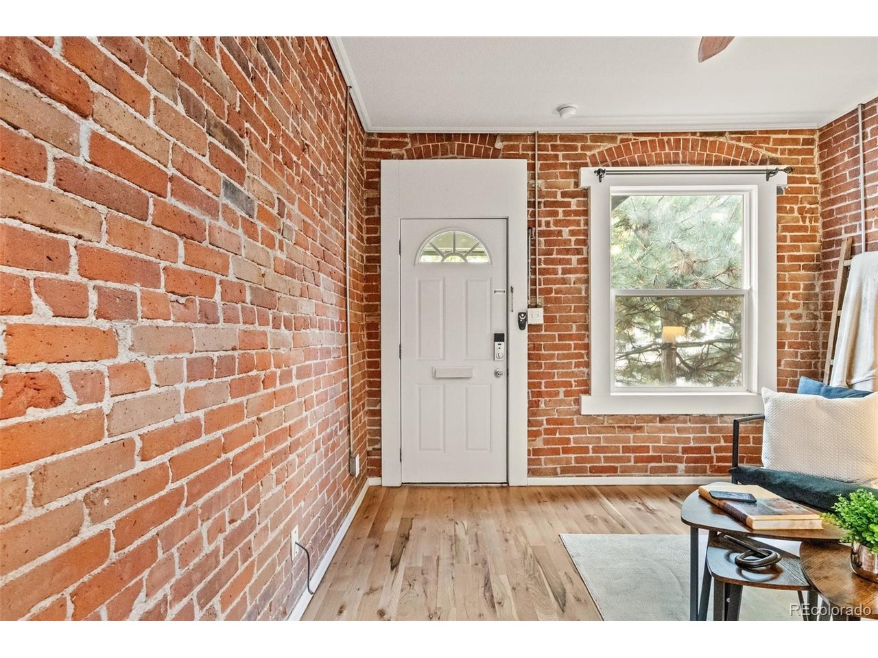 321 Inca Street Denver, CO 80223 - Photo 9 of 27 a view of an empty room with wooden floor and a window
