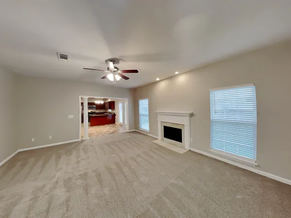 a view of an empty room with a fireplace