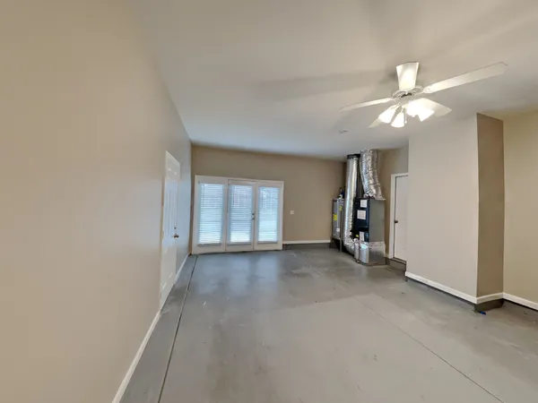 an empty room with closet and a ceiling fan