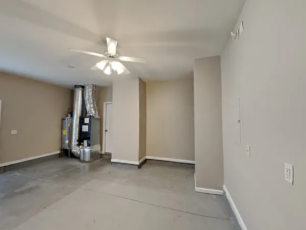 an empty room with closet and a chandelier fan