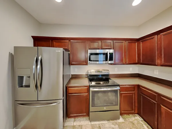 a kitchen with a refrigerator stove and microwave
