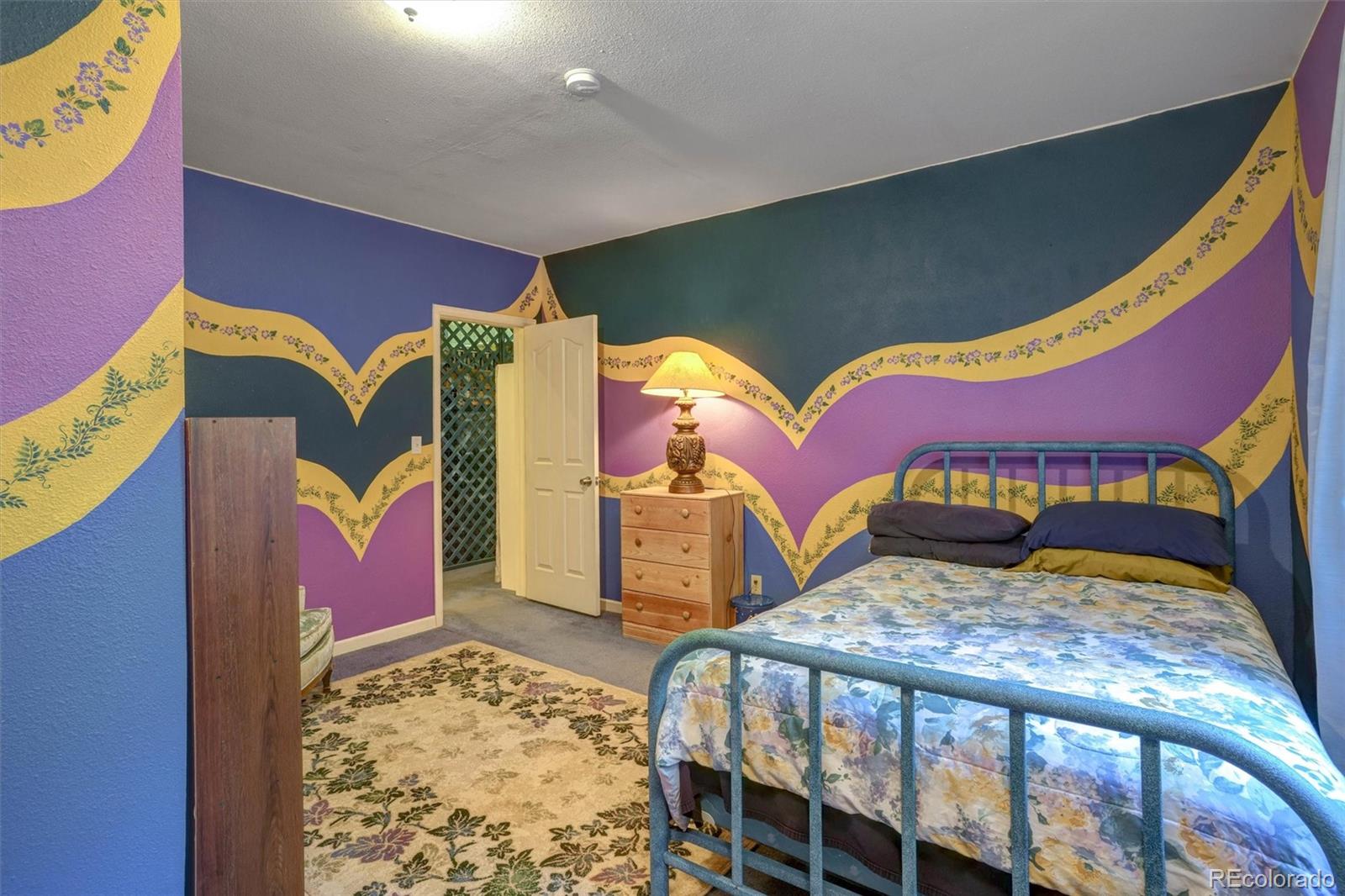 1206 Biddle Street Georgetown, CO 80444 - Photo 6 of 32 a bed room with a bed and a couch