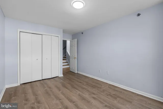 a bathroom with a granite countertop sink mirror and toilet