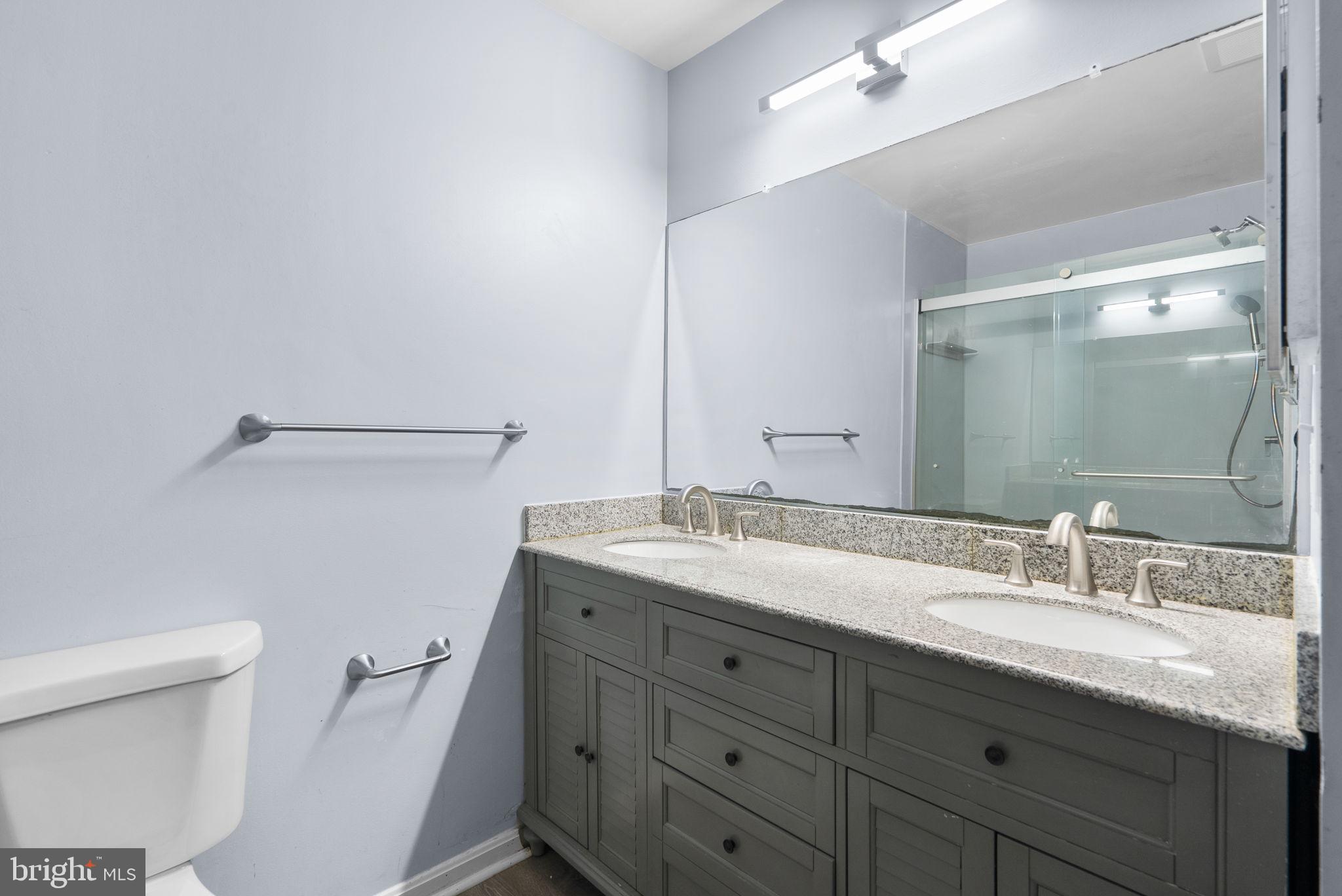 13137 Broadmore Road Silver Spring, MD 20904 - Photo 16 of 28 a bathroom with a granite countertop sink mirror and toilet