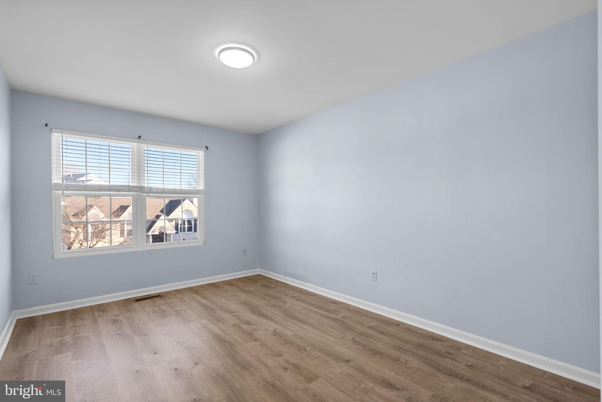 13137 Broadmore Road Silver Spring, MD 20904 - Photo 19 of 28 an empty room with wooden floor and windows