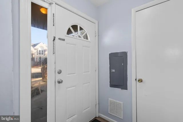a view of a kitchen with a sink and a refrigerator
