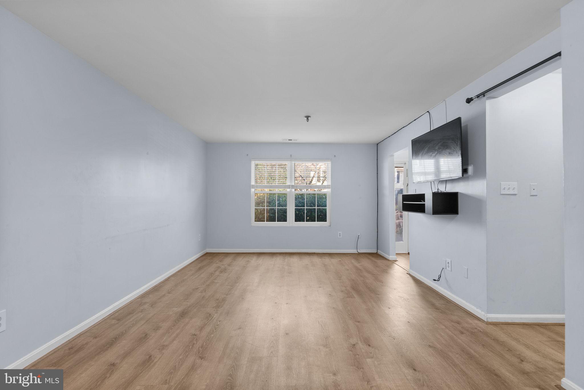 13137 Broadmore Road Silver Spring, MD 20904 - Photo 7 of 28 a view of an empty room with window and hardwood floor