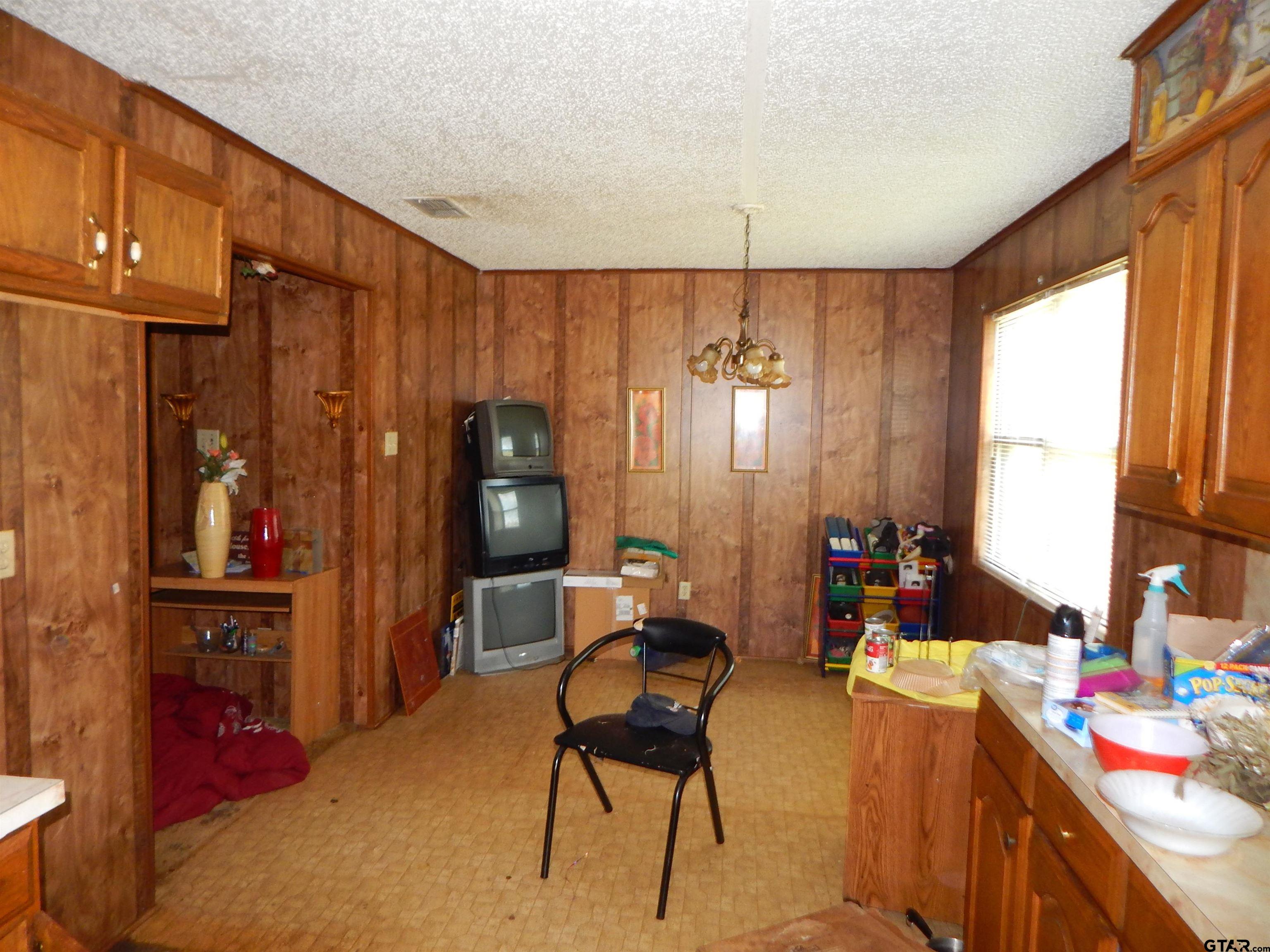 2741 Toad Road Gilmer, TX 75644 - Photo 12 of 20 a bed room with a bed furniture and a window