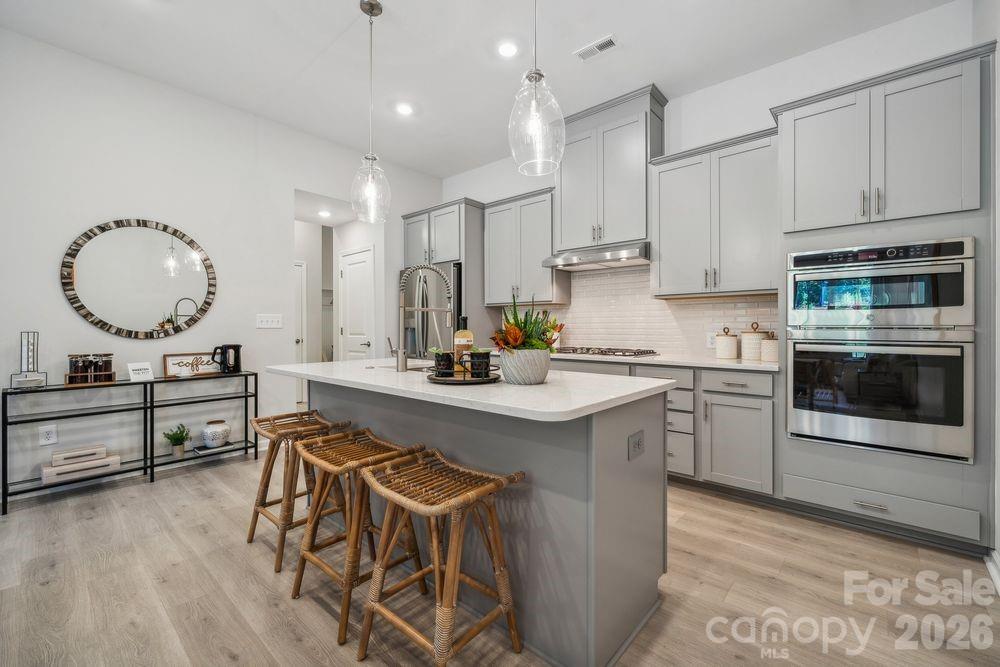 3168 Beacon Hts Road Indian Land, SC 29707 - Photo 1 of 36 a kitchen with a table chairs sink and cabinets