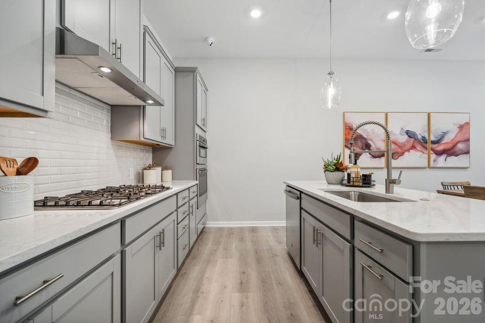3168 Beacon Hts Road Indian Land, SC 29707 - Photo 11 of 36 a kitchen with stainless steel appliances a sink stove and cabinets