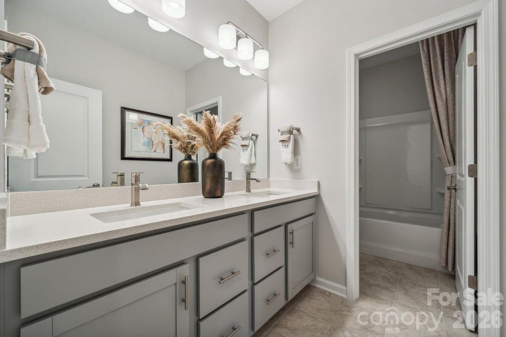 3168 Beacon Hts Road Indian Land, SC 29707 - Photo 22 of 36 a bathroom with a double vanity sink a vanity and a mirror
