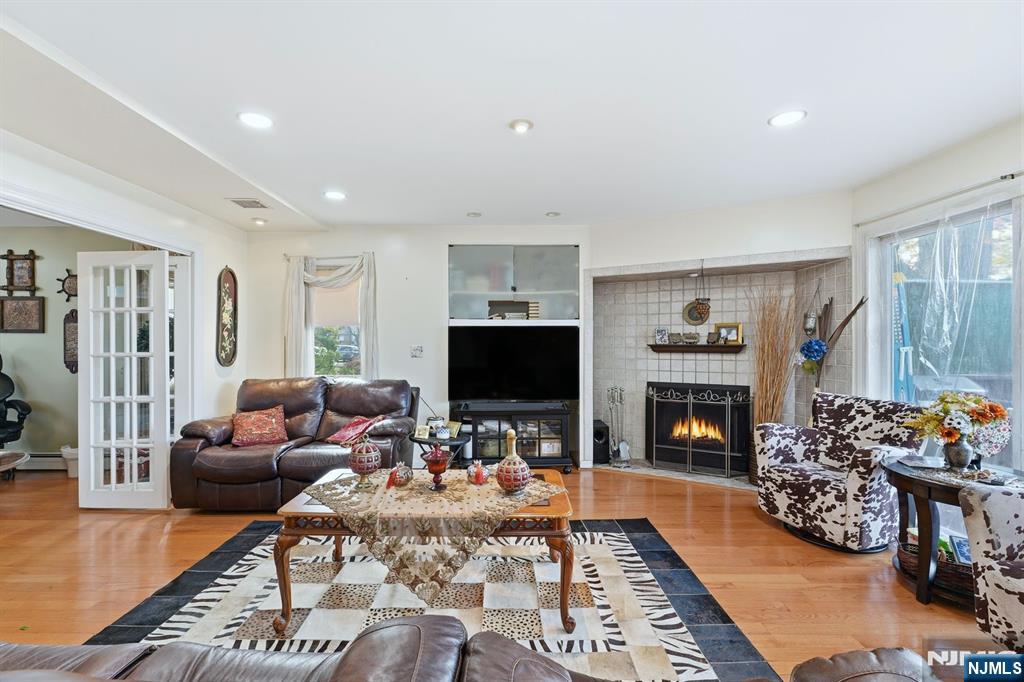 703 Stewart Street Ridgefield, NJ 07657 - Photo 13 of 38 a living room with furniture and a fireplace