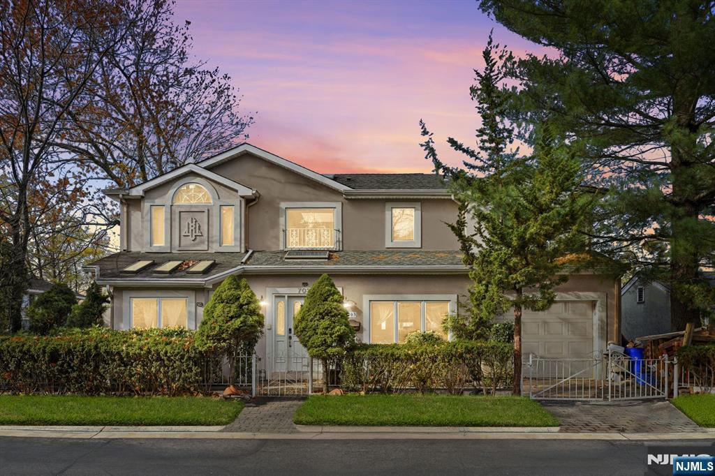703 Stewart Street Ridgefield, NJ 07657 - Photo 2 of 38 a front view of a house with garden