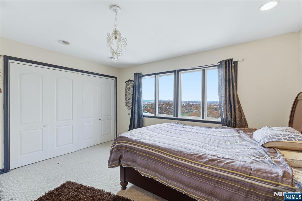 703 Stewart Street Ridgefield, NJ 07657 - Photo 22 of 38 a bedroom with a bed and large window