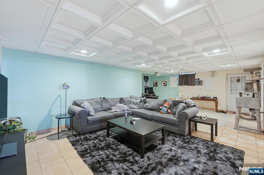 703 Stewart Street Ridgefield, NJ 07657 - Photo 26 of 38 a living room with furniture and wooden floor